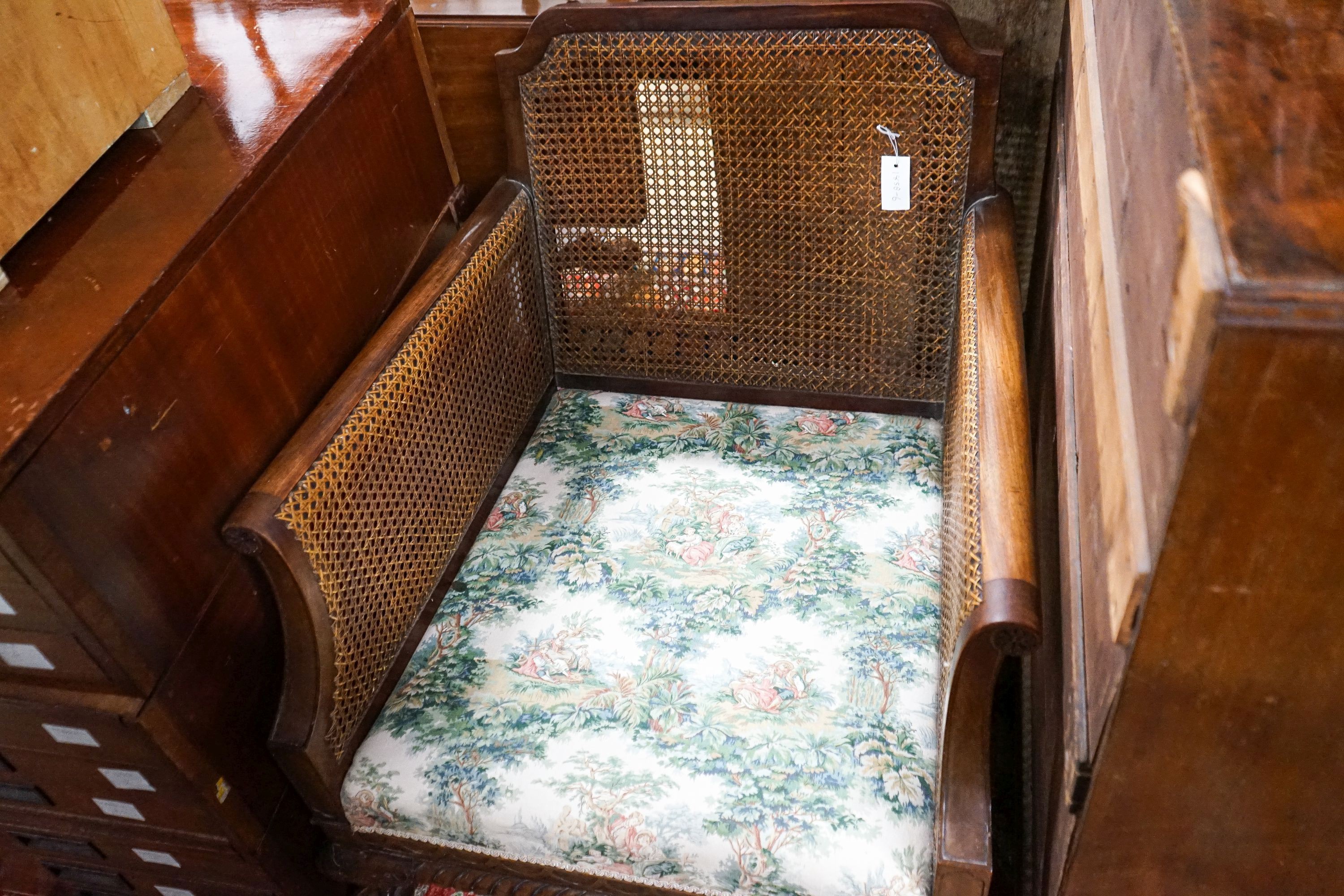 A 1920's mahogany single caned bergere armchair, width 75cm, depth 80cm, height 80cm
